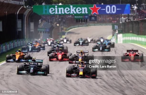 Max Verstappen of the Netherlands driving the Red Bull Racing RB16B Honda and Valtteri Bottas of Finland driving the Mercedes AMG Petronas F1 Team...