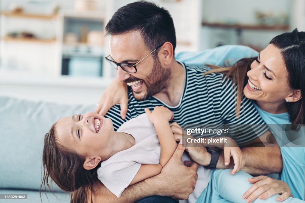 Happy family with a girl having fun at home