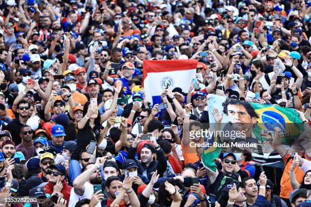 Fans run onto the track to enjoy the podium celebrations during the F1 Grand Prix of Brazil at Autodromo Jose Carlos Pace on November 14, 2021 in Sao...