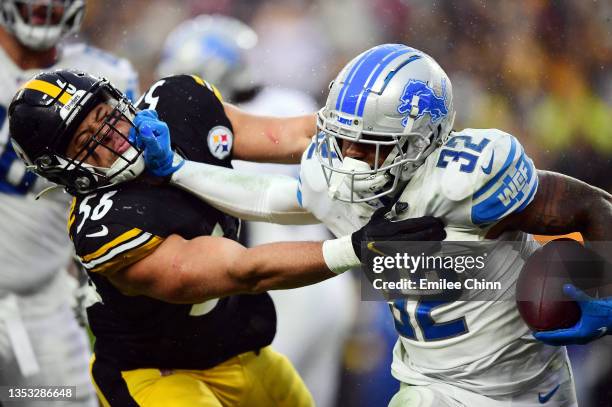 Andre Swift of the Detroit Lions stiff arms Alex Highsmith of the Pittsburgh Steelers during the fourth quarter at Heinz Field on November 14, 2021...