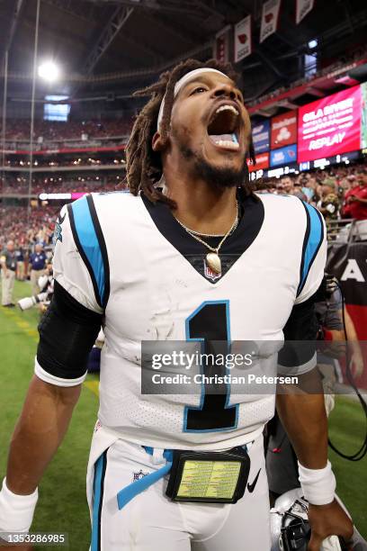 Cam Newton of the Carolina Panthers reacts after scoring on a rushing touchdown against the Arizona Cardinals in the first quarter at State Farm...