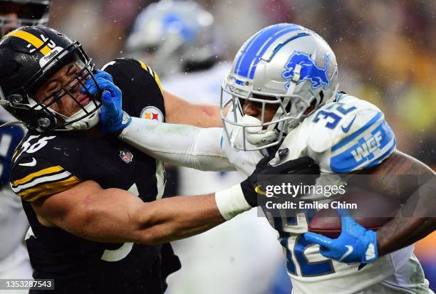 Andre Swift of the Detroit Lions stiff arms Alex Highsmith of the Pittsburgh Steelers during the fourth quarter at Heinz Field on November 14, 2021...