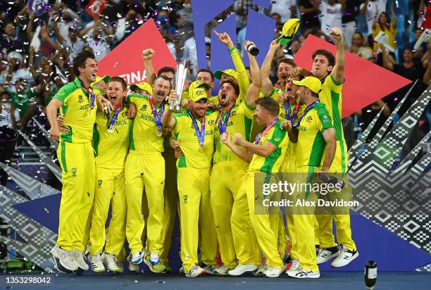 Aaron Finch of Australia lifts the ICC World T20 Trophy with teammates after the ICC Men's T20 World Cup final match between New Zealand and...