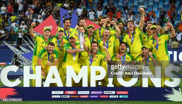 Aaron Finch of Australia lifts the ICC World T20 Trophy with teammates after the ICC Men's T20 World Cup final match between New Zealand and...