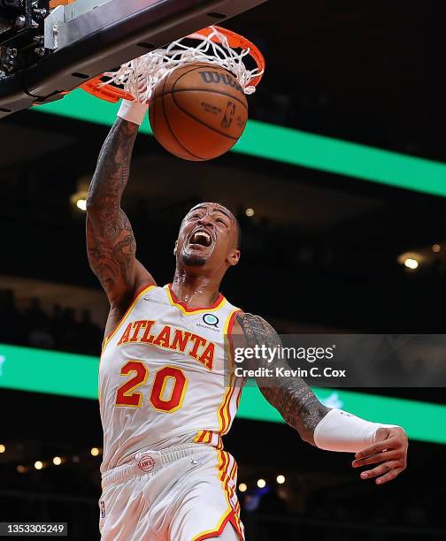 John Collins of the Atlanta Hawks dunks against the Milwaukee Bucks during the first half at State Farm Arena on November 14, 2021 in Atlanta,...