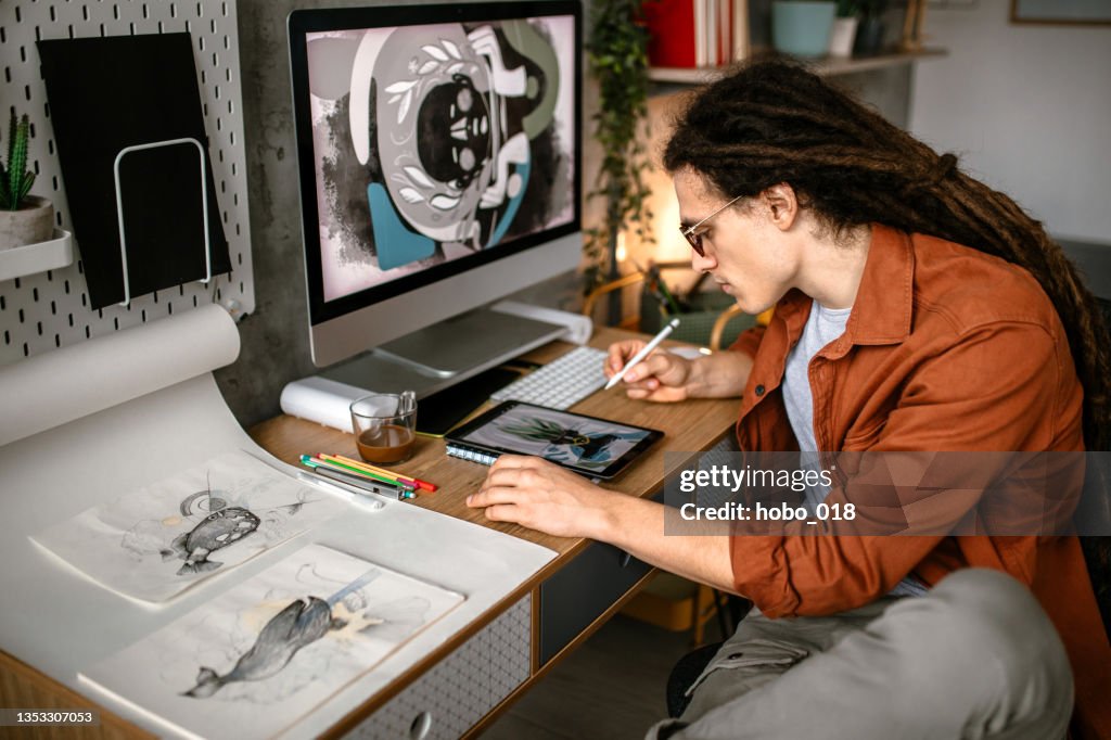 Creative graphic designer using digital tablet and computer