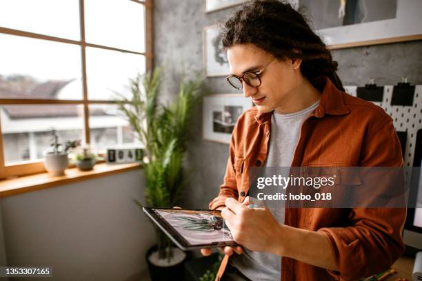 sketching new graphic design solutions - artist drawing stock pictures, royalty-free photos & images
