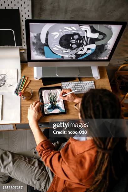 creative graphic designer using digital tablet and computer, creating new design solutions - graphic designer stock pictures, royalty-free photos & images