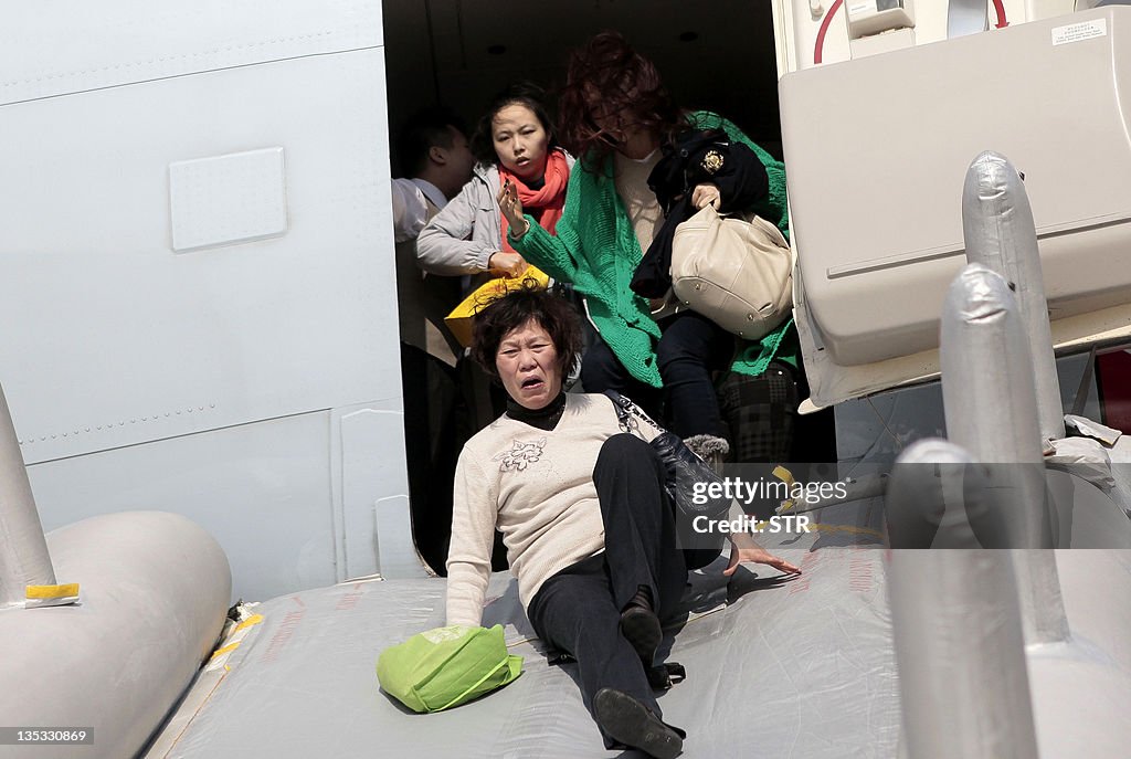 Passengers are evacuated from a Cathay P