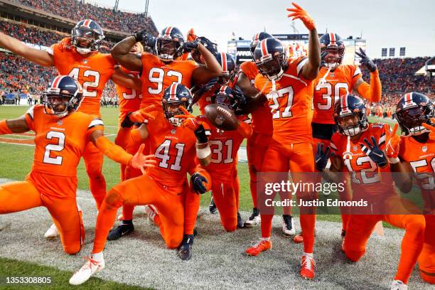 Justin Simmons of the Denver Broncos celebrates an interception with teammates during the third quarter against the Philadelphia Eagles at Empower...