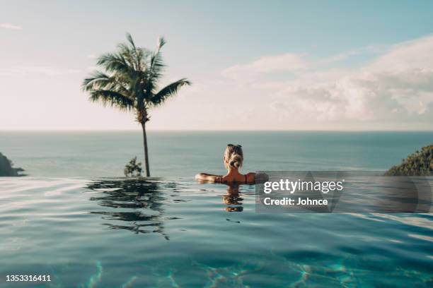 woman enjoying the amazing sea view - infinity pool stock pictures, royalty-free photos & images