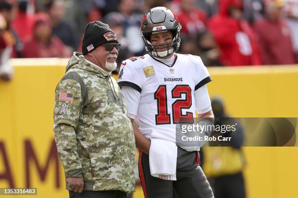 Head coach Bruce Arians of the Tampa Bay Buccaneers talks with quarterback Tom Brady against the Washington Football Team at FedExField on November...