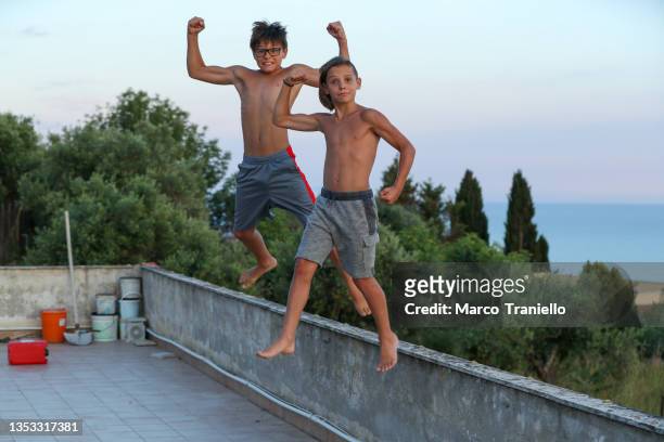 roof jump - fraternal twin stock pictures, royalty-free photos & images
