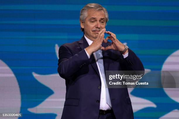 President of Argentina Alberto Fernandez makes the shape of a heart after the legislative midterm elections at the Frente de Todos party bunker on...