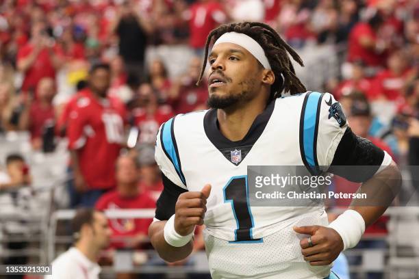 Quarterback Cam Newton of the Carolina Panthers runs out to the field before the NFL game against the Arizona Cardinals at State Farm Stadium on...