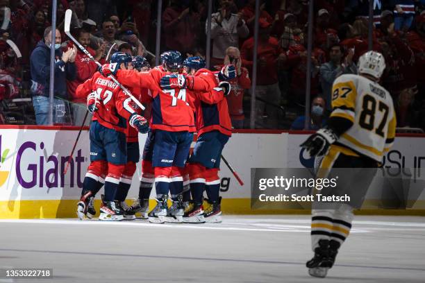 Evgeny Kuznetsov of the Washington Capitals celebrates with teammates after scoring a goal against as Sidney Crosby of the Pittsburgh Penguins looks...