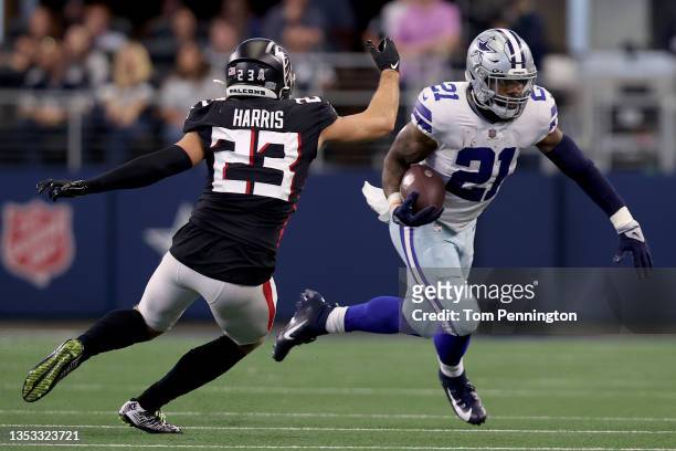 Ezekiel Elliott of the Dallas Cowboys carries the ball against Erik Harris of the Atlanta Falcons during the second quarter at AT&T Stadium on...