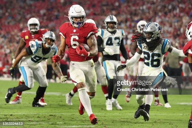 Running back James Conner of the Arizona Cardinals scores on a 11-yard rushing touchdown past cornerback Donte Jackson of the Carolina Panthers...