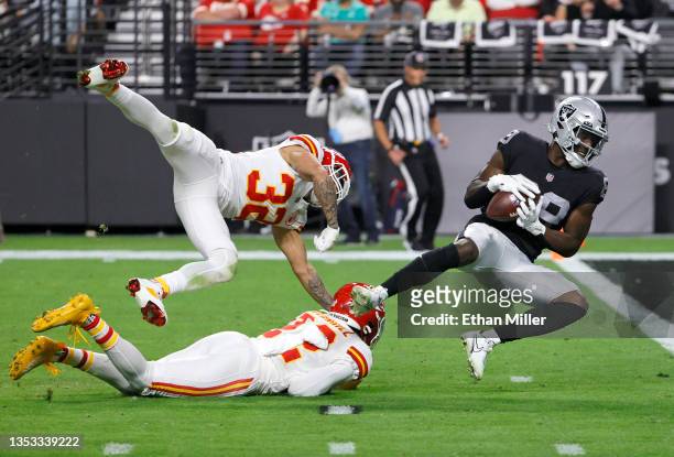 Wide receiver Bryan Edwards of the Las Vegas Raiders scores a touchdown on a 37-yard pass play against free safety Tyrann Mathieu and safety Juan...