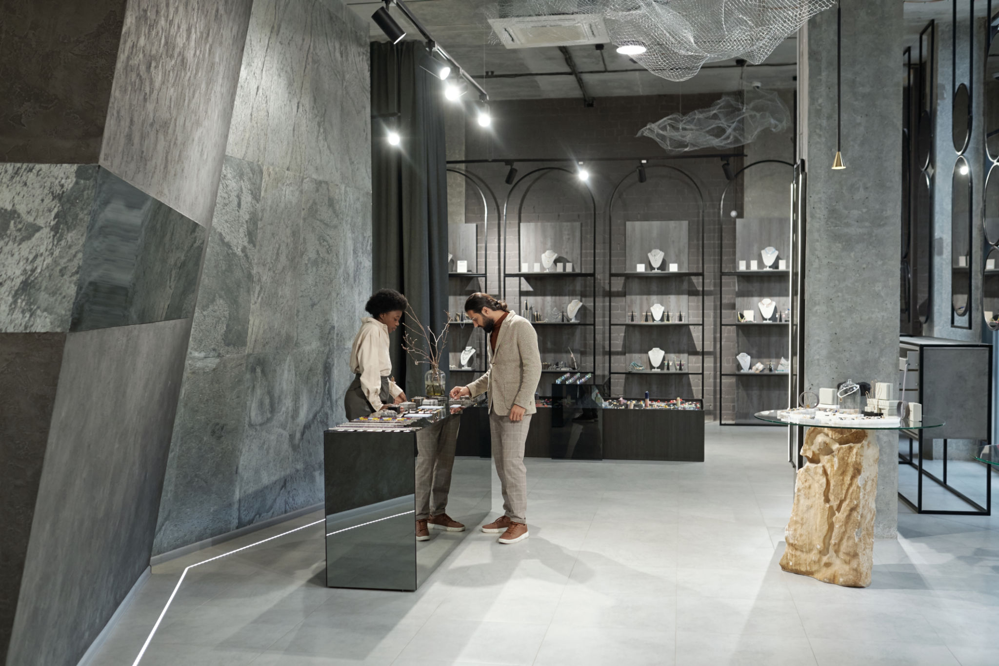 Interior of jewelry boutique with buyer and shop assistant Interior of jewelry boutique with buyer and shop assistant