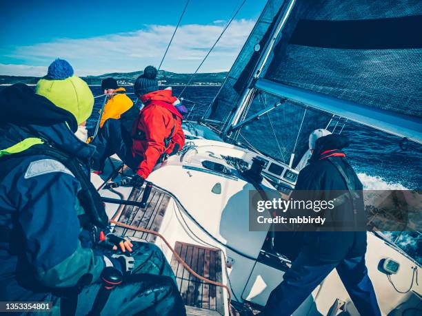 sailing crew on sailboat on regatta on sunny autumn morning - sailing team stock pictures, royalty-free photos & images
