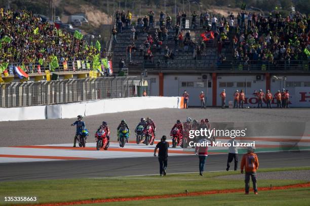 The MotoGP riders celebrate Valentino Rossi of Italy and Petronas Yamaha SRT on track during the MotoGP of Comunitat Valenciana: Race at Ricardo...