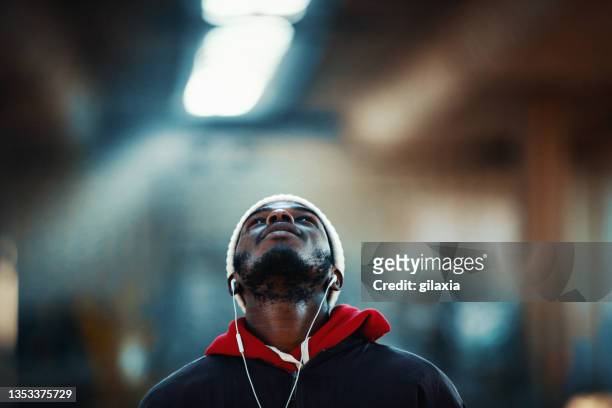 street portrait of a young african american man. - city life authentic stock pictures, royalty-free photos & images