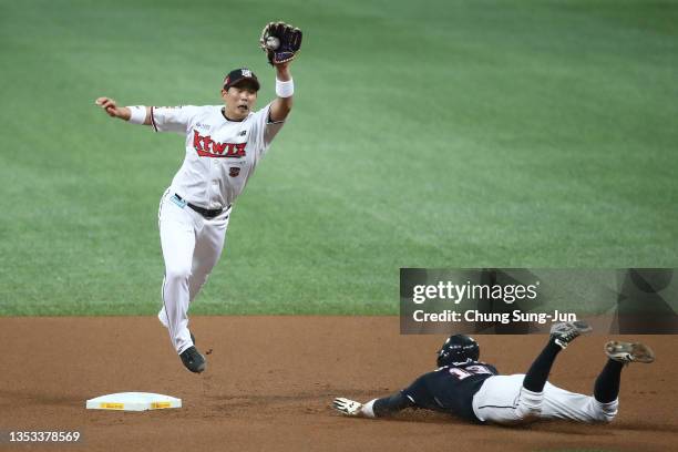 Infielder Heo Kyoung-Min of Doosan Bears slides into second base as Infielder Park Kyung-Su of KT Wiz try to tags in the top of first inning during...