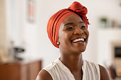 Cheerful african woman wearing trendy red headscarf