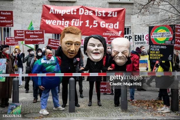 Climate activists dressed as Christian Lindner of the German Free Democratic Party , Olaf Scholz of the German Social Democrats and German Greens...