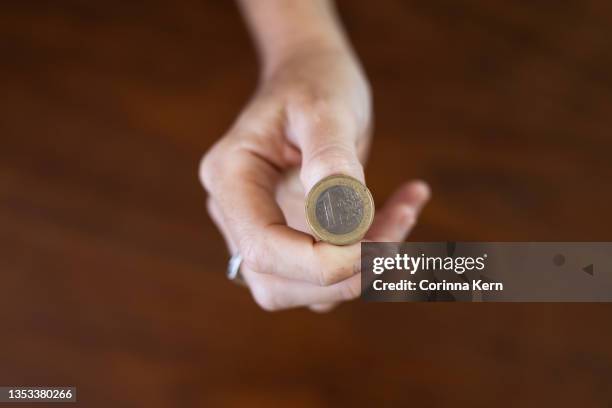 hand holding euro coin - coin toss stockfoto's en -beelden