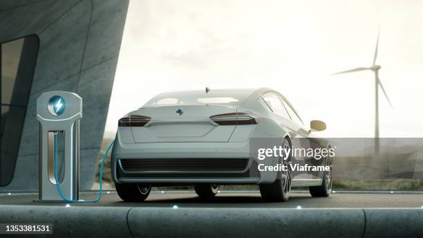 electric car charging with wind turbines - voiture digital photos et images de collection