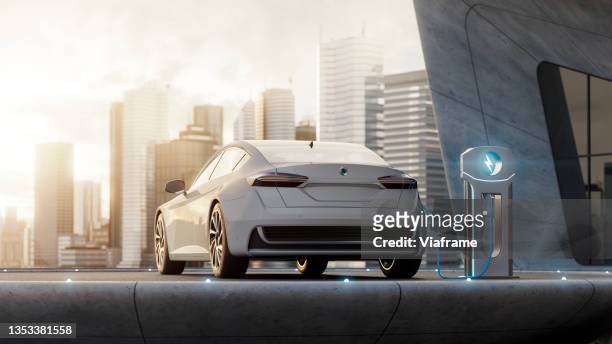 electric car charging with city - automotive future stock pictures, royalty-free photos & images