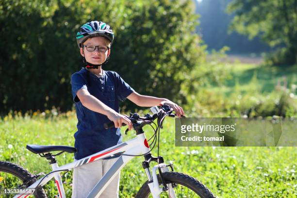 boy on his bike in nature - teenager cycling helmet stock pictures, royalty-free photos & images