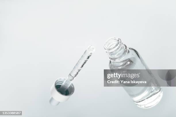 glass beauty product bottle with a dropper from below - face serum stock pictures, royalty-free photos & images