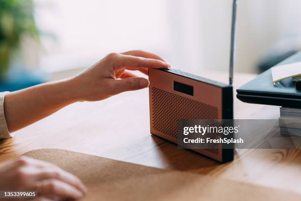 close up of woman hand adjusting the sound volume on the radio - radio listening stock pictures, royalty-free photos & images