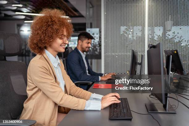 multiracial coworkers in the office, working on their computers - account manager stock pictures, royalty-free photos & images