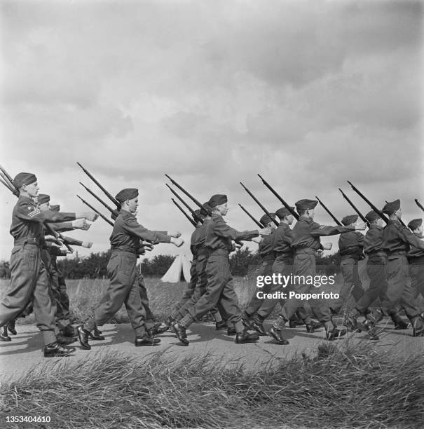 Volunteer members of the Army Cadet Force of the British Army's Honourable Artillery Company take part in rifle drill at their training camp at Goffs...