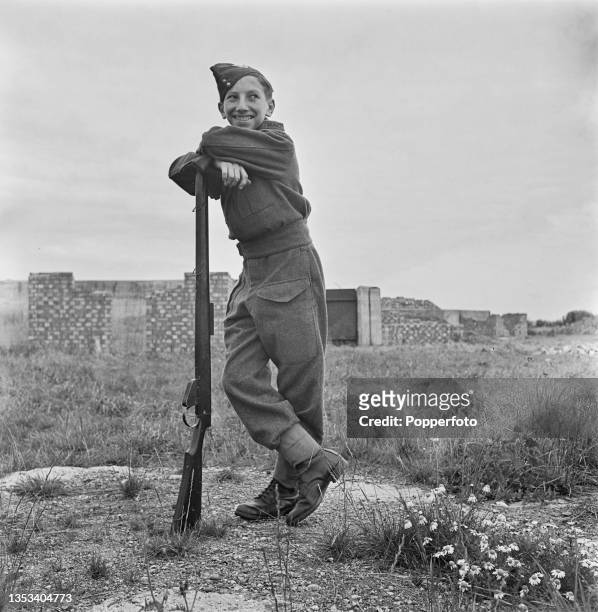 Volunteer member of the Army Cadet Force of the British Army's Honourable Artillery Company posed with a rifle at his training camp at Goffs Oak near...