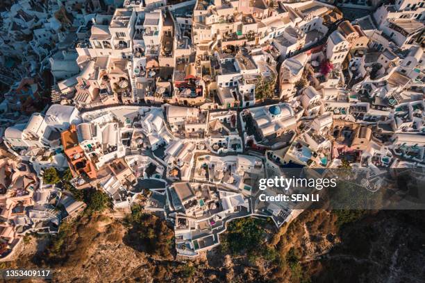 aerial view of the oia village at sunrise on santorini island, greece - mediterranean-blue-roof-santorini stock pictures, royalty-free photos & images