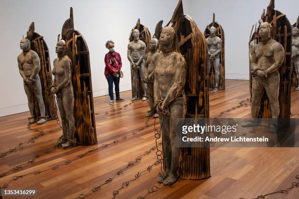 People view a sculpture installation by the artist Stephen Hayes titled Crash Crop, depicting slaves on a slave ship, November 13 at the Cameron Art...