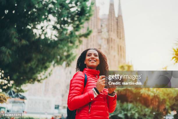 tourist woman with camera exploring bracelona - winter barcelona stock pictures, royalty-free photos & images