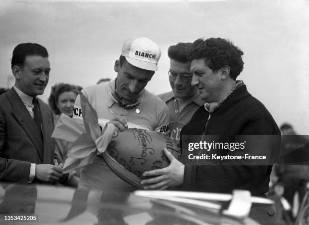 Raphaël Géminiani signant un oeuf de Pâques après sa victoire à la course Paris-Roubaix, le 13 avril 1952.