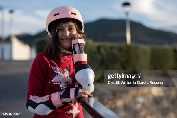 skating girl with helmet in city outdoors, posing girl smiling - girl roller skates stock pictures, royalty-free photos & images