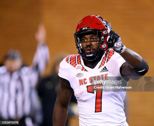 Zonovan Knight of the North Carolina State Wolfpack reacts after returning the opening kickoff of the second half for a touchdown against the Wake...