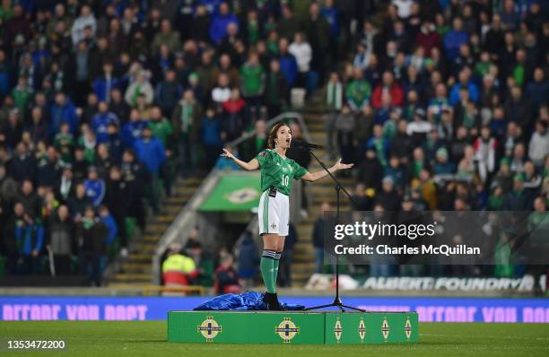 Singer sings the national anthem's prior to the 2022 FIFA World Cup Qualifier match between Northern Ireland and Italy at Windsor Park on November...