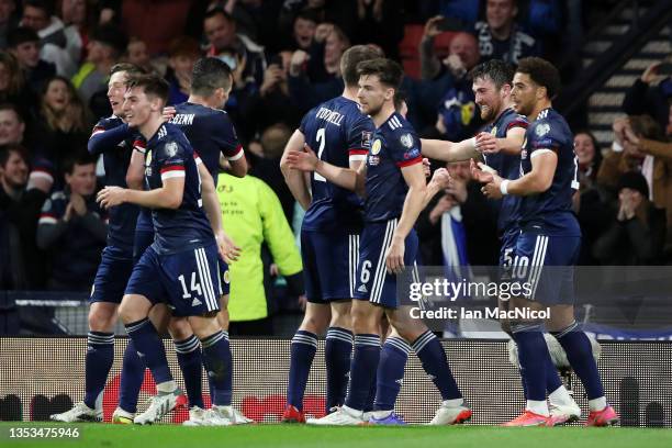 John Souttar of Scotland celebrates with team mates after scoring their team's first goal during the 2022 FIFA World Cup Qualifier match between...
