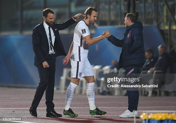 Harry Kane of England shakes hands with Steve Holland, Assistant Manager of England as Gareth Southgate, Manager of England pats him on the back...