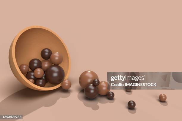 rendering of chocolate spheres coming out of a bowl - bombones chocolate stock-fotos und bilder