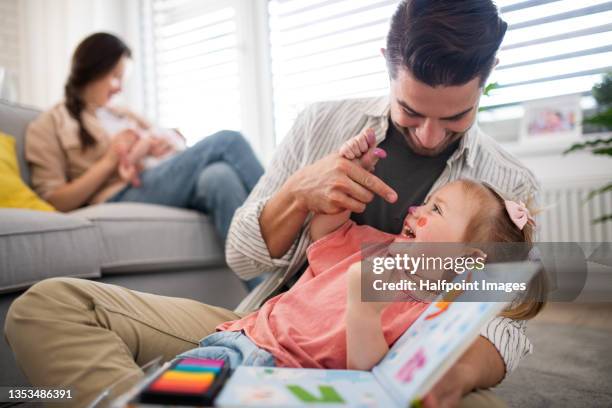 happy young family with newborn baby and little girl enjoying time together at home. - happy dirty child stockfoto's en -beelden